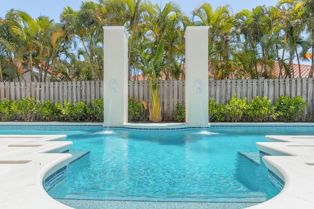 view of swimming pool with pool water feature