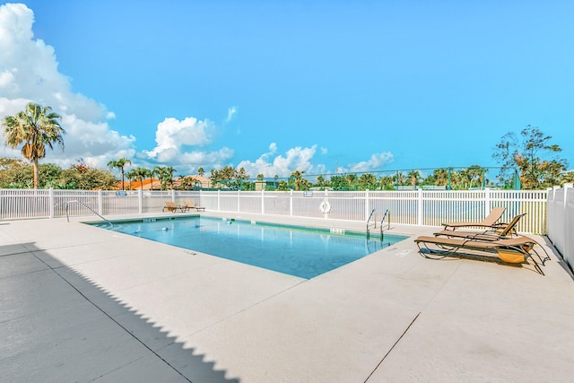 view of swimming pool with a patio