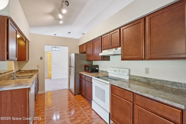 kitchen with white appliances, a textured ceiling, light tile patterned floors, and sink