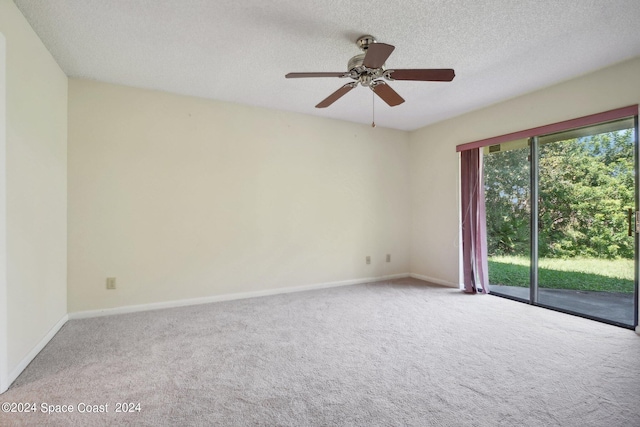 empty room with a textured ceiling, carpet, and ceiling fan