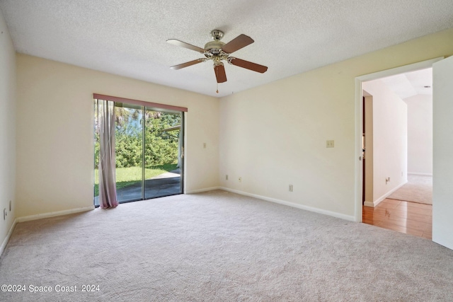 carpeted empty room with a textured ceiling and ceiling fan