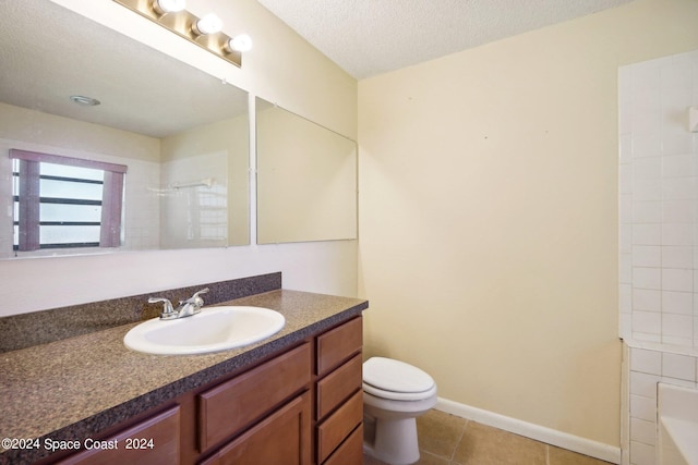 bathroom featuring a textured ceiling, vanity, toilet, and tile patterned floors