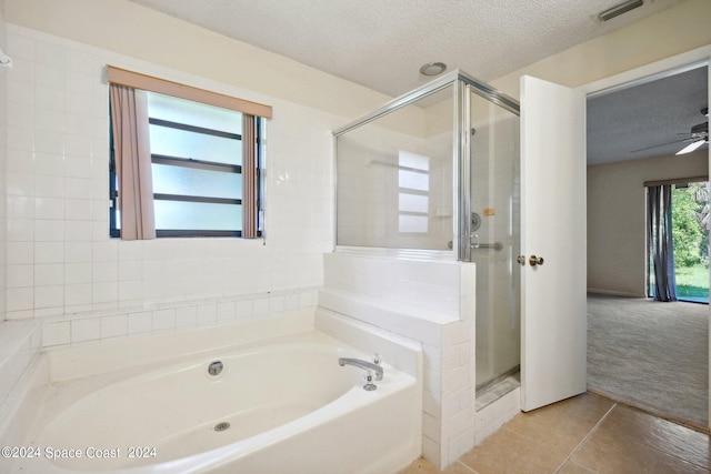 bathroom featuring a textured ceiling, separate shower and tub, ceiling fan, and tile patterned floors