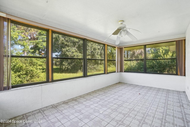 unfurnished sunroom featuring ceiling fan