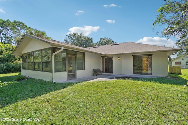 view of front of home with a patio, a front lawn, and a sunroom