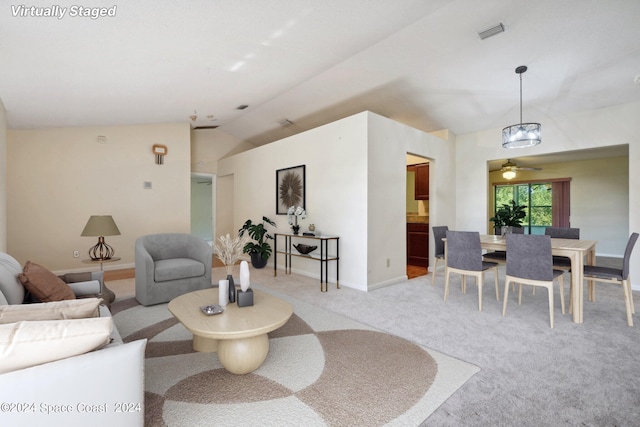 carpeted living room with lofted ceiling and ceiling fan