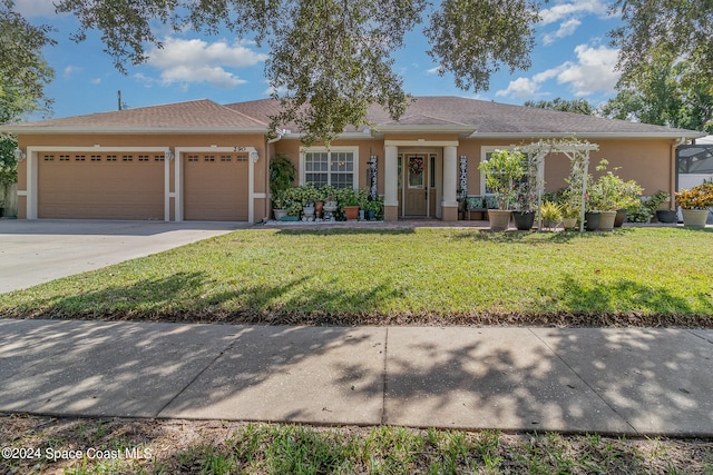 ranch-style house featuring a front yard and a garage