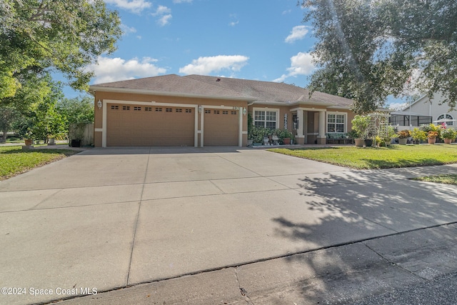 view of front of property featuring a garage and a front yard