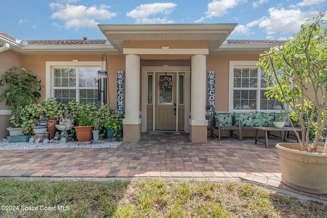 view of exterior entry with a porch