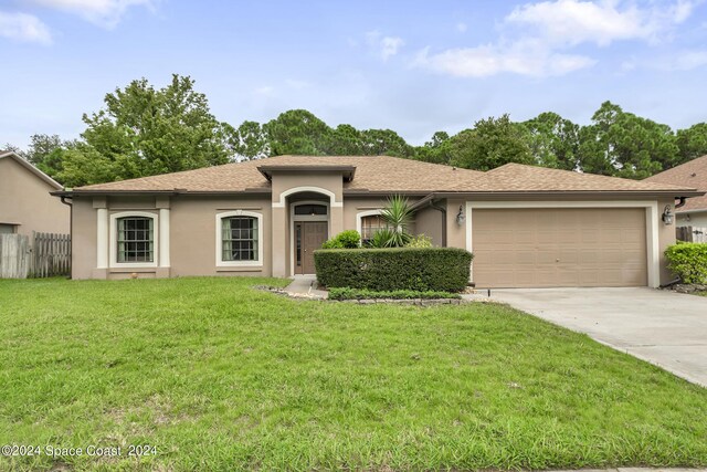 view of front of home featuring a garage and a front lawn