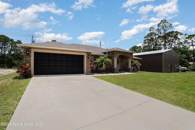 view of front of house with a front yard and a garage