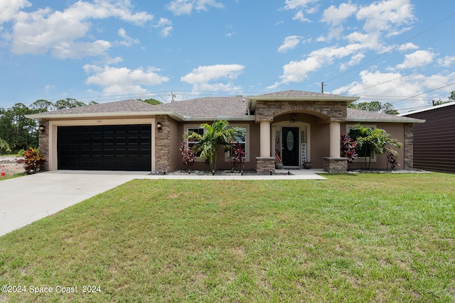 view of front of house featuring a garage and a front yard