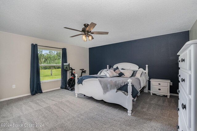 bedroom with ceiling fan, a textured ceiling, and carpet