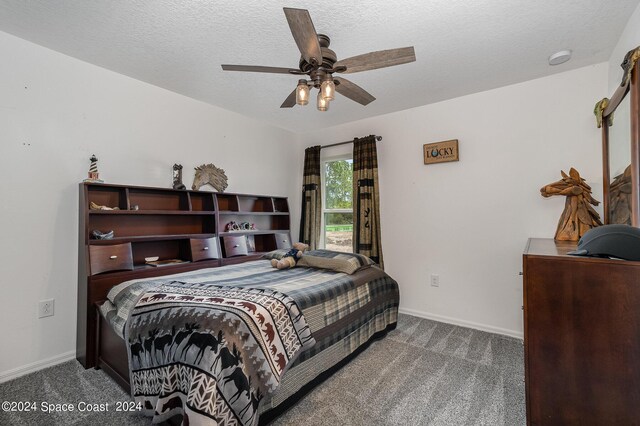 carpeted bedroom featuring a textured ceiling and ceiling fan