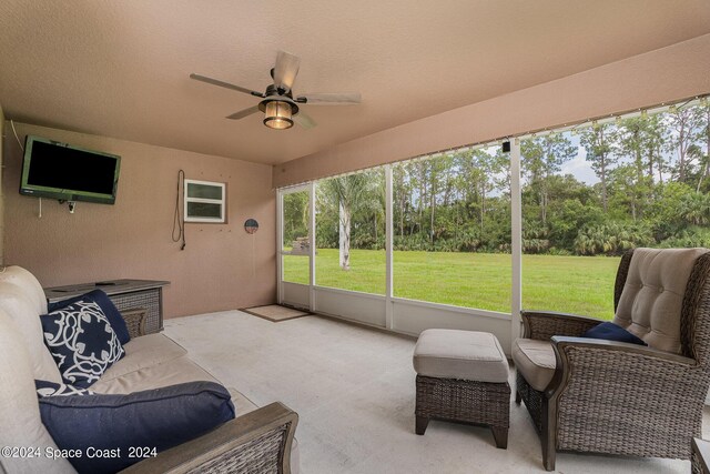 sunroom featuring ceiling fan