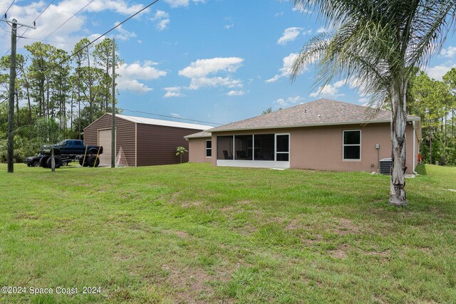 back of property with a lawn, cooling unit, and a sunroom