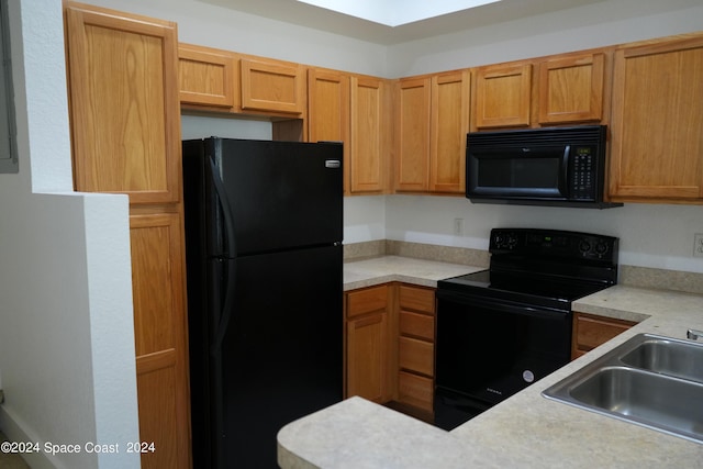 kitchen featuring black appliances and sink