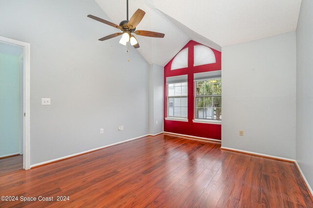 unfurnished room featuring dark hardwood / wood-style flooring, ceiling fan, and high vaulted ceiling