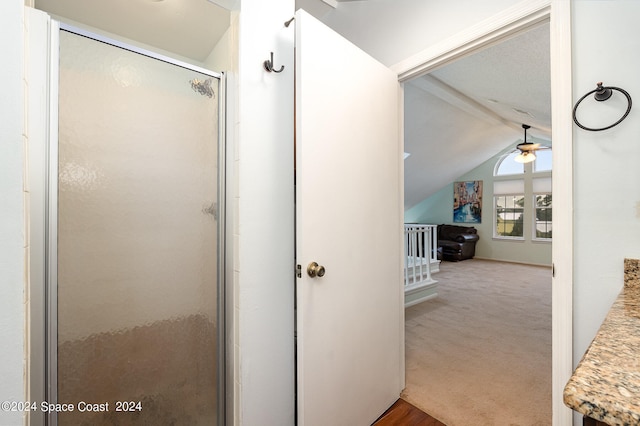 bathroom with walk in shower, lofted ceiling with beams, vanity, and ceiling fan