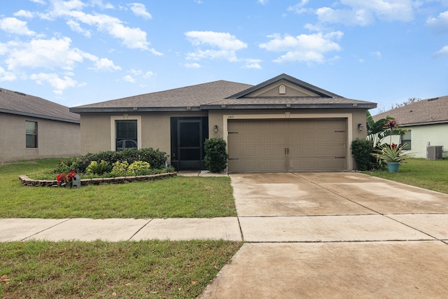 ranch-style house featuring a garage, a front lawn, and central air condition unit