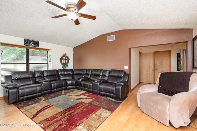 living room featuring lofted ceiling, wood-type flooring, ceiling fan, and a textured ceiling