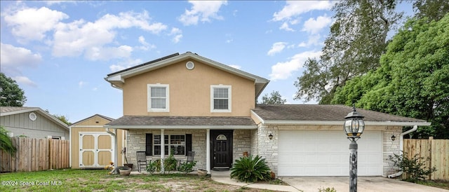 view of front property with a garage and a porch