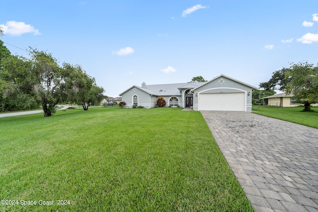 ranch-style house with a garage and a front lawn