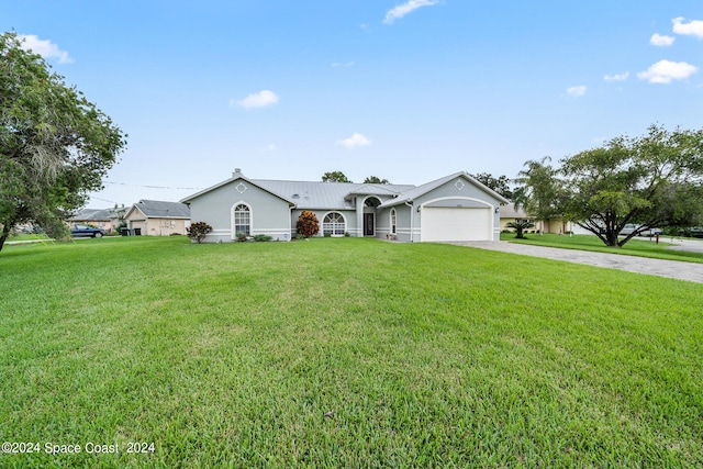 ranch-style home featuring a garage and a front lawn