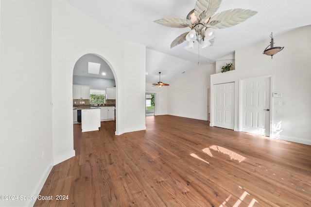 empty room featuring ceiling fan, hardwood / wood-style floors, and high vaulted ceiling