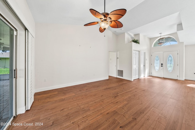 unfurnished living room featuring ceiling fan, hardwood / wood-style flooring, and high vaulted ceiling