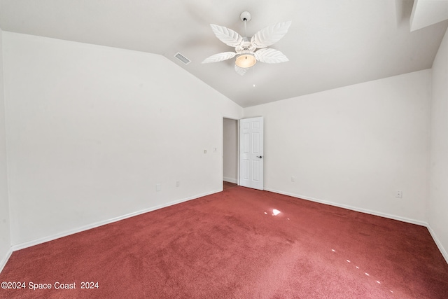 spare room with vaulted ceiling, ceiling fan, and carpet floors