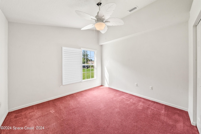 spare room featuring ceiling fan and carpet