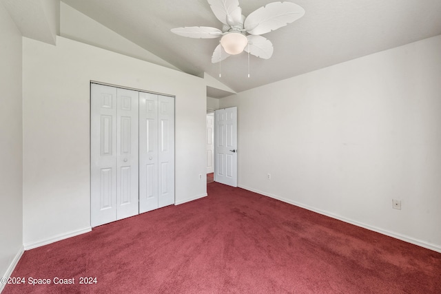 unfurnished bedroom with carpet floors, lofted ceiling, ceiling fan, and a closet