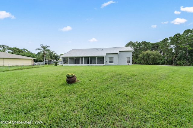 exterior space featuring a sunroom and a front lawn