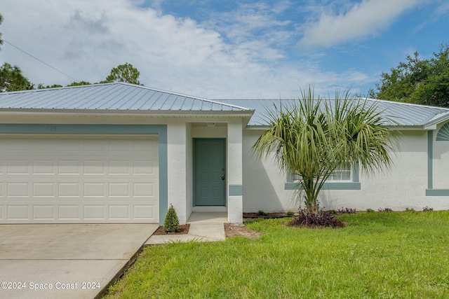 single story home featuring a garage and a front yard