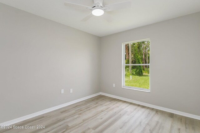 empty room with light hardwood / wood-style floors and ceiling fan