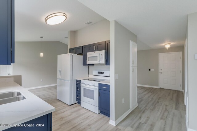 kitchen with light wood-type flooring, vaulted ceiling, white appliances, decorative light fixtures, and light stone countertops