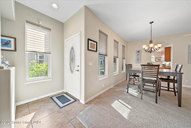 interior space with a chandelier and light tile patterned flooring