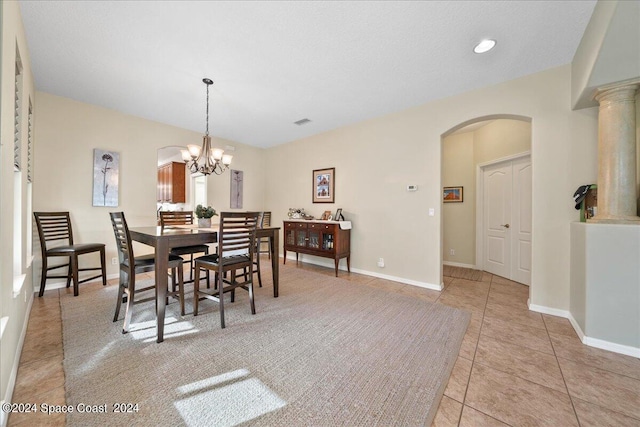 dining room with a notable chandelier and light tile patterned floors