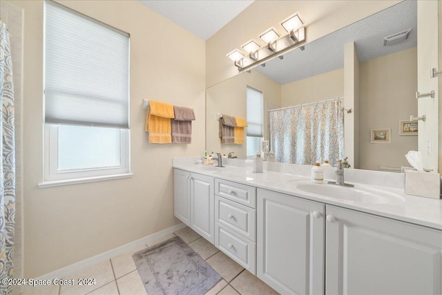 bathroom featuring a shower with shower curtain, tile patterned floors, and vanity