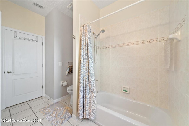 bathroom with a textured ceiling, shower / bath combo, toilet, and tile patterned floors