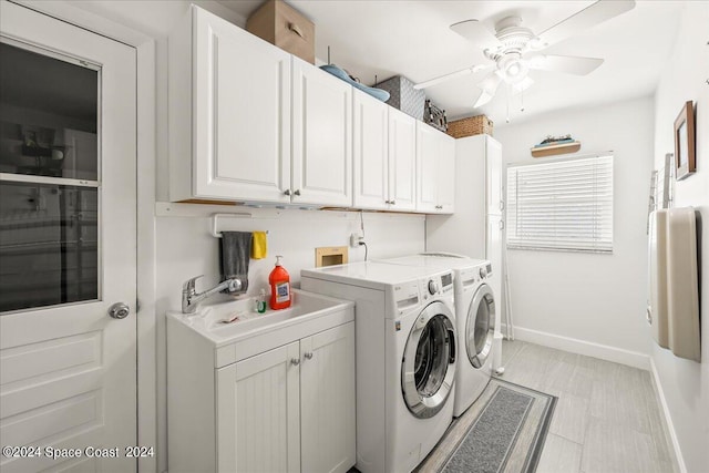 washroom with cabinets, ceiling fan, sink, and washer and clothes dryer