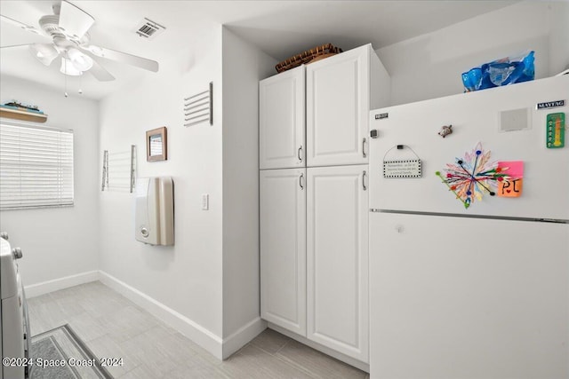 kitchen with white cabinetry, ceiling fan, and white fridge