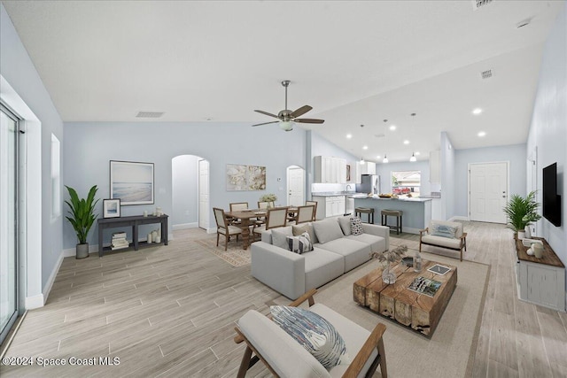 living room featuring high vaulted ceiling and ceiling fan