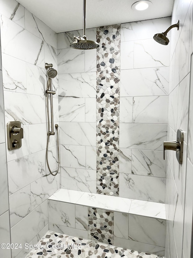 bathroom with a tile shower