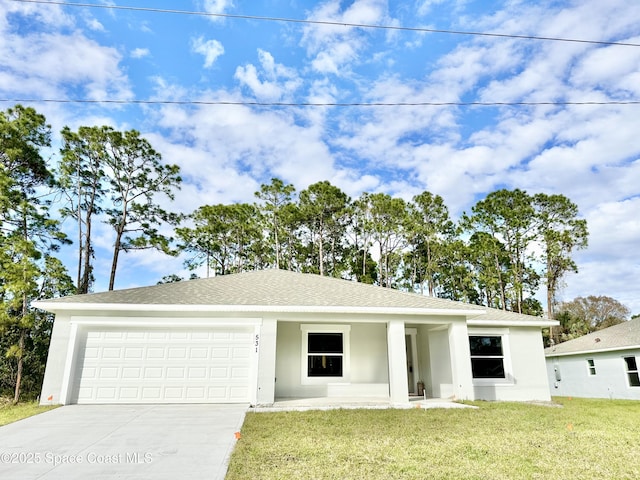 view of front of property with a garage and a front yard