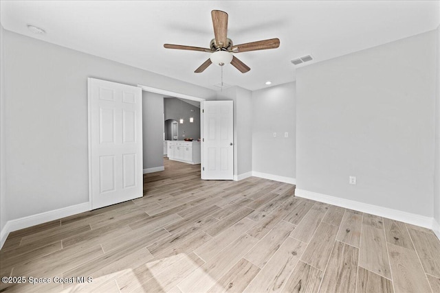 unfurnished bedroom with light wood-type flooring, baseboards, visible vents, and a ceiling fan