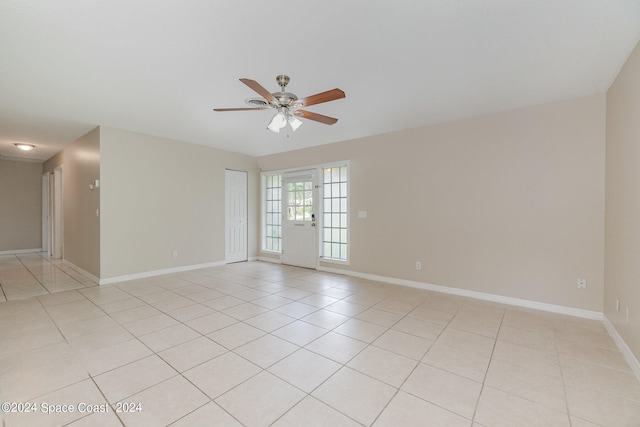 tiled empty room with ceiling fan