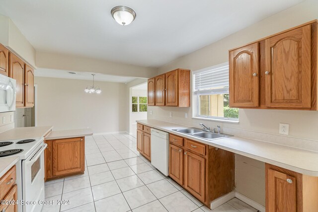 kitchen featuring white appliances, light tile patterned floors, pendant lighting, an inviting chandelier, and sink