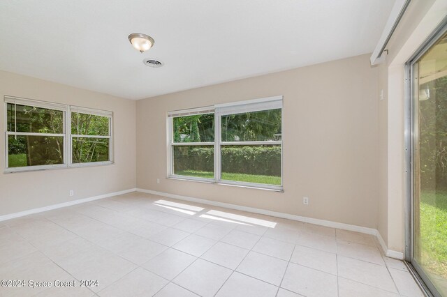 tiled spare room with plenty of natural light